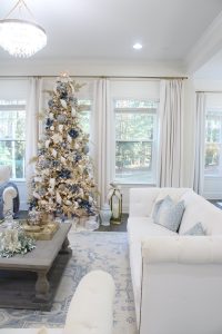white and gold decor, glam christmas, white walls, ginger jars, classy christmas, christmas blogger tour, white sofas, custom pillow covers, flocked christmas tree, flocked garland christmas mantel