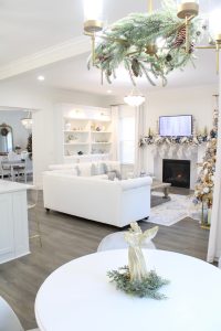 white and gold decor, glam christmas, white walls, ginger jars, classy christmas, christmas blogger tour, white sofas, custom pillow covers, flocked christmas tree, flocked garland christmas mantel, white built-ins