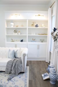 white built-ins with gold lighting, christmas bookshelf styling